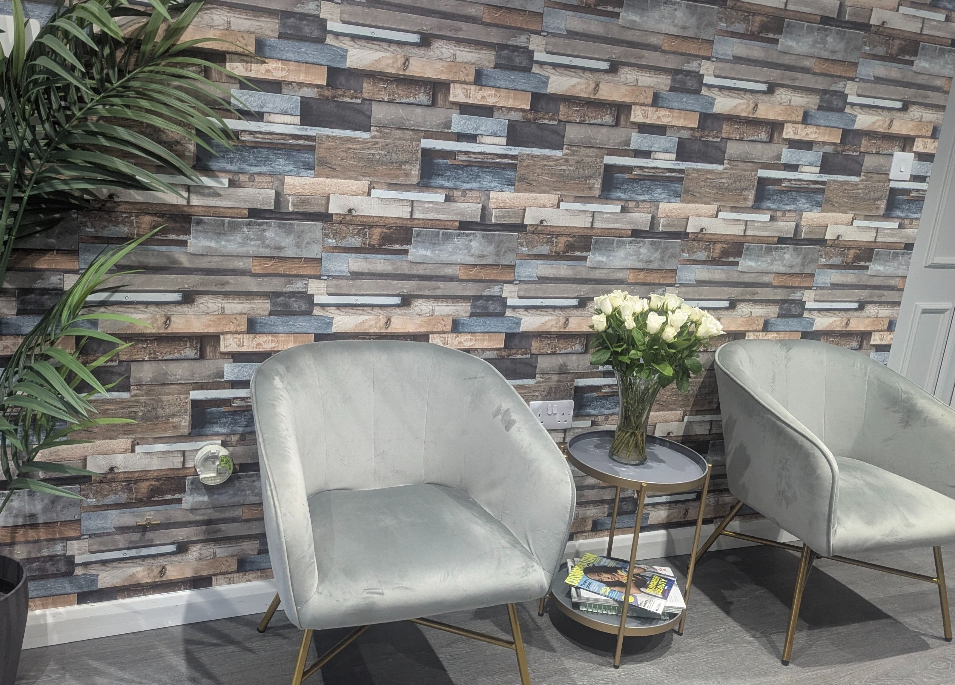 Stylish waiting area at Hair By Mia, Carlisle, England, GB with plush chairs and greenery.