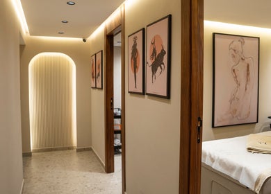 Intérieur élégant de Yur maison de beauté à Casablanca, MA, présentant des œuvres d'art murales et une table de massage.