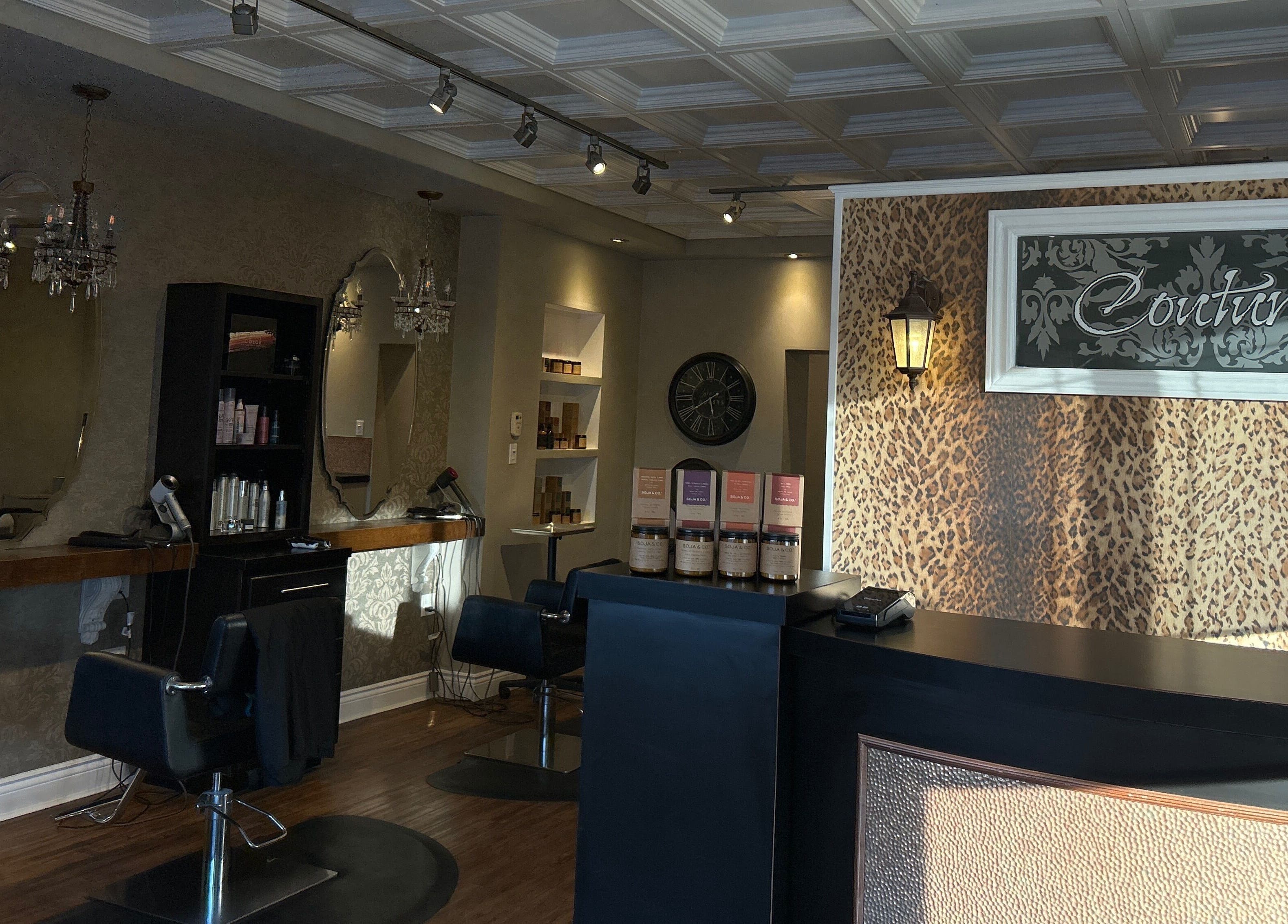 Chic interior of Couture Hair Studio & Spa, Mitchell, Ontario, CA with stylish chairs and large mirrors.