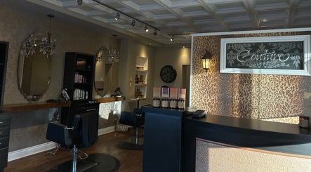 Chic interior of Couture Hair Studio & Spa, Mitchell, Ontario, CA with stylish chairs and large mirrors.