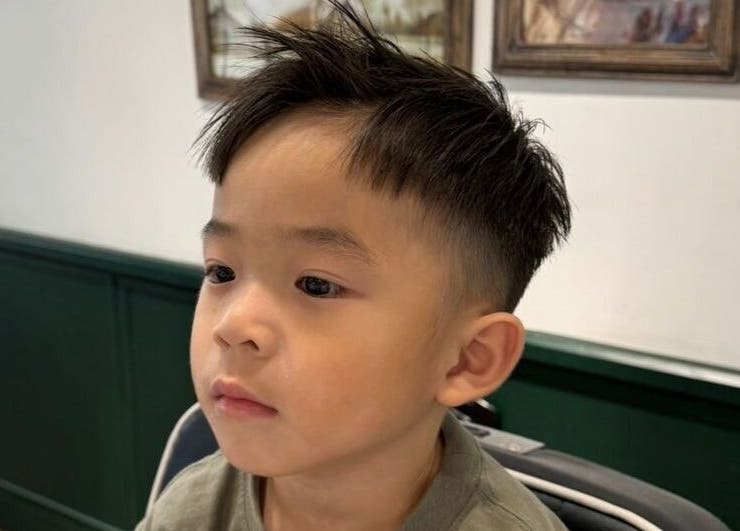 Child with trendy haircut at Coffee Ng, 香港島, 香港島, HK, showcasing a chic hairstyle.