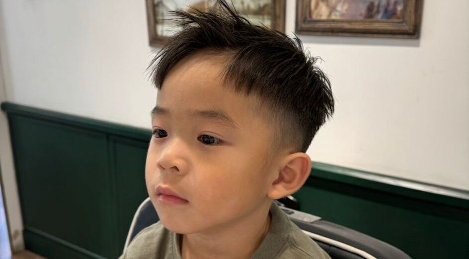Child with trendy haircut at Coffee Ng, 香港島, 香港島, HK, showcasing a chic hairstyle.