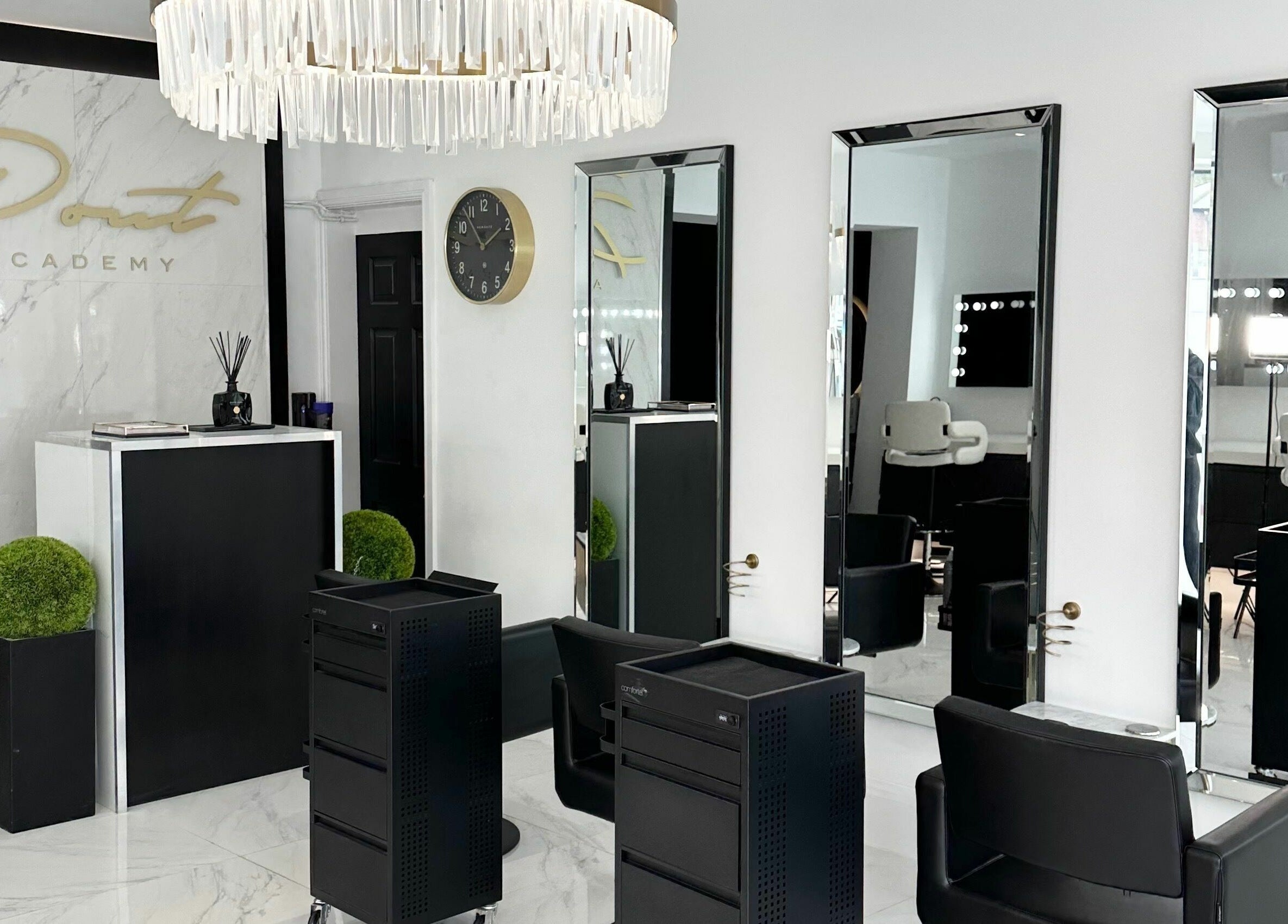 Chic interior of Pout in Whitefield, England, GB with mirrors, plush chairs, and decorative elements.