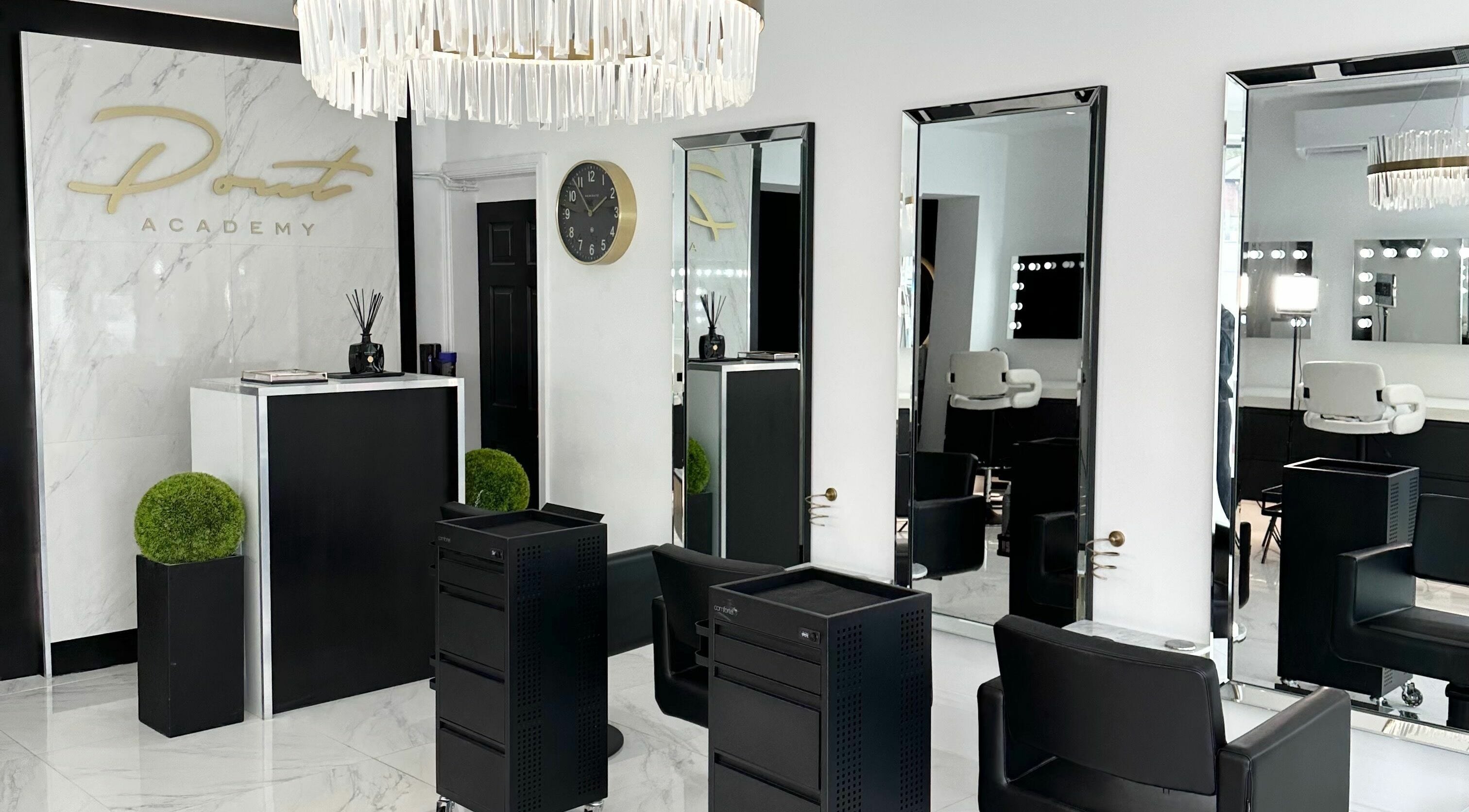 Chic interior of Pout in Whitefield, England, GB with mirrors, plush chairs, and decorative elements.