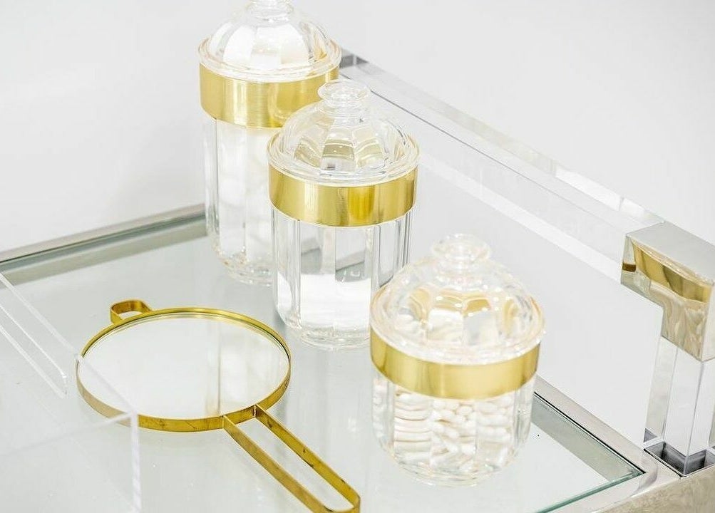 Elegant glass and gold beauty jars at Pout, Whitefield, England, GB, showcasing sophisticated wellness decor.