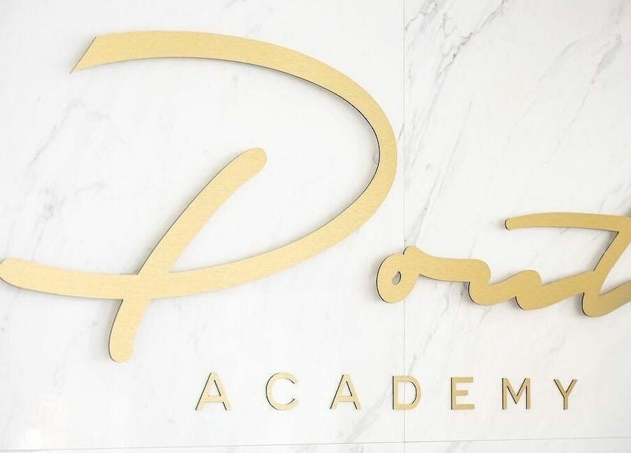 Gold Pout logo on white marble at Pout, Whitefield, England, GB.