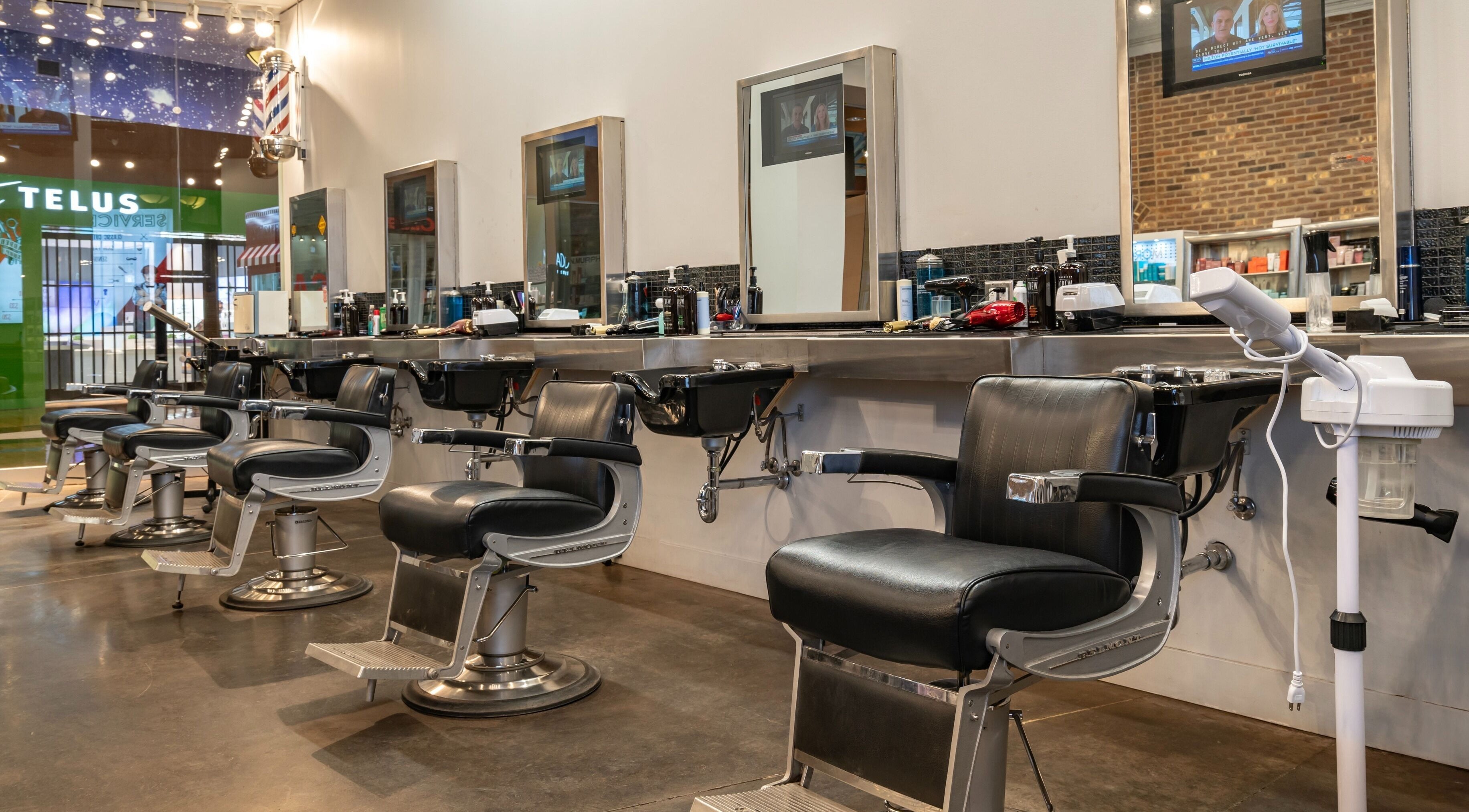 Sleek interior of Denim & Smith Barbershops, Alberta, Alberta, CA with modern barber chairs and mirrors.