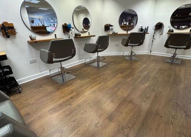 Modern salon chairs and mirrors at Kai @ Opulent Hair & Beauty, Cudworth, England, GB.