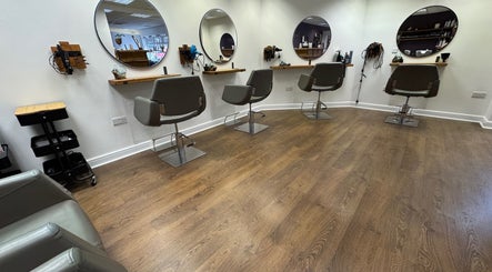 Modern salon chairs and mirrors at Kai @ Opulent Hair & Beauty, Cudworth, England, GB.
