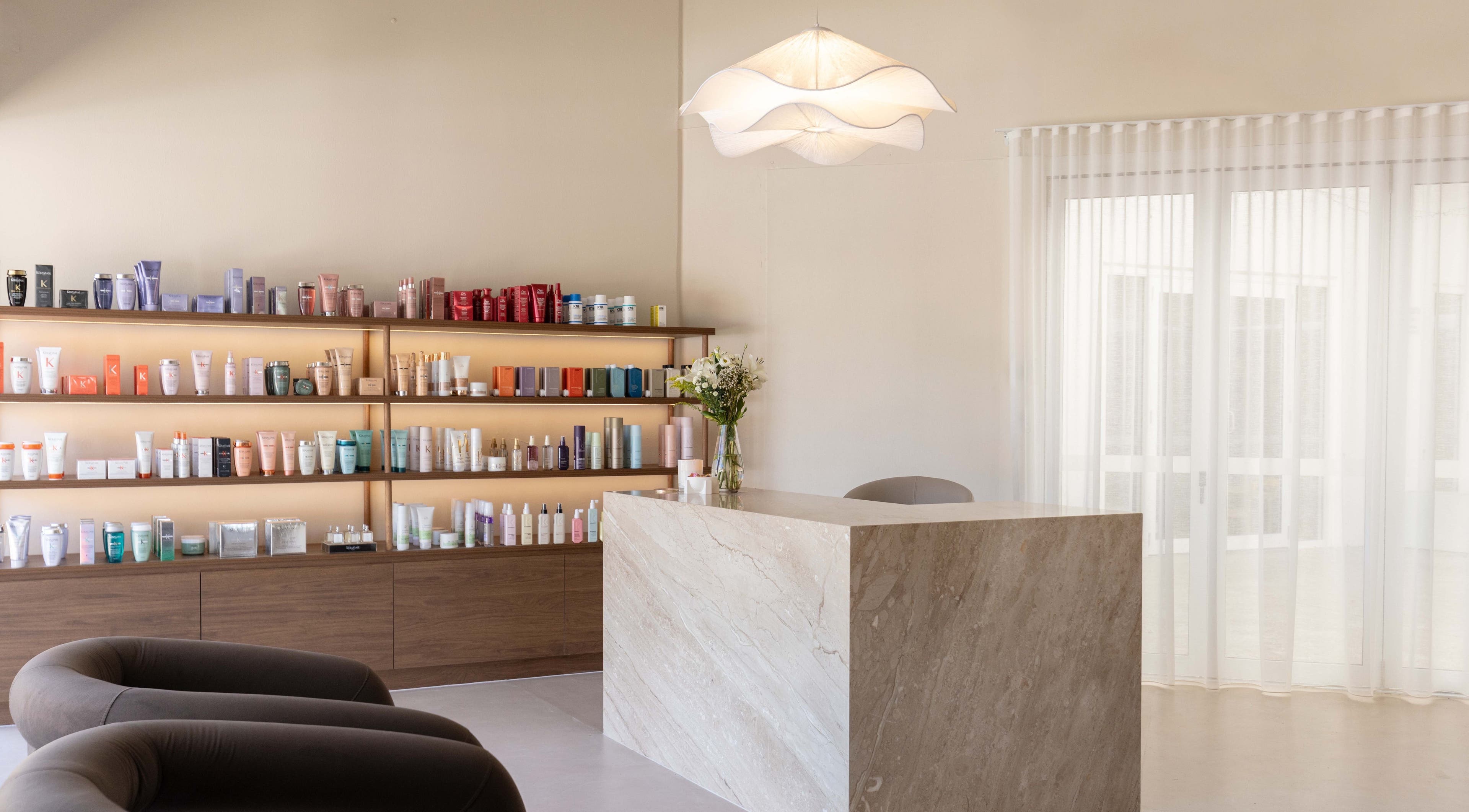 Chic reception at Blondee | Burleigh with product shelves in Burleigh Waters, Queensland, AU.