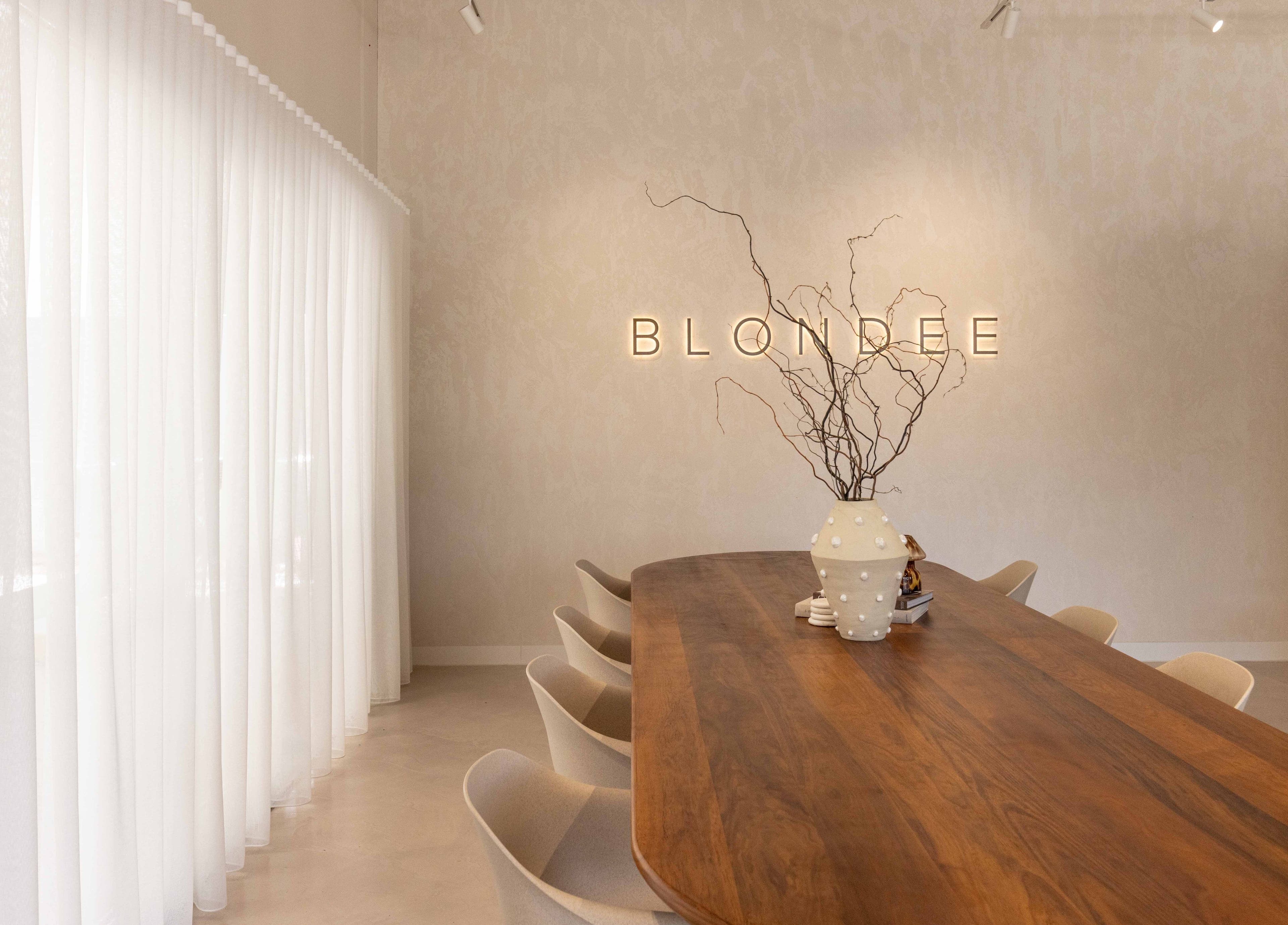 Blondee | Burleigh's elegant meeting space in Burleigh Waters, Queensland, AU with a stylish wooden table.