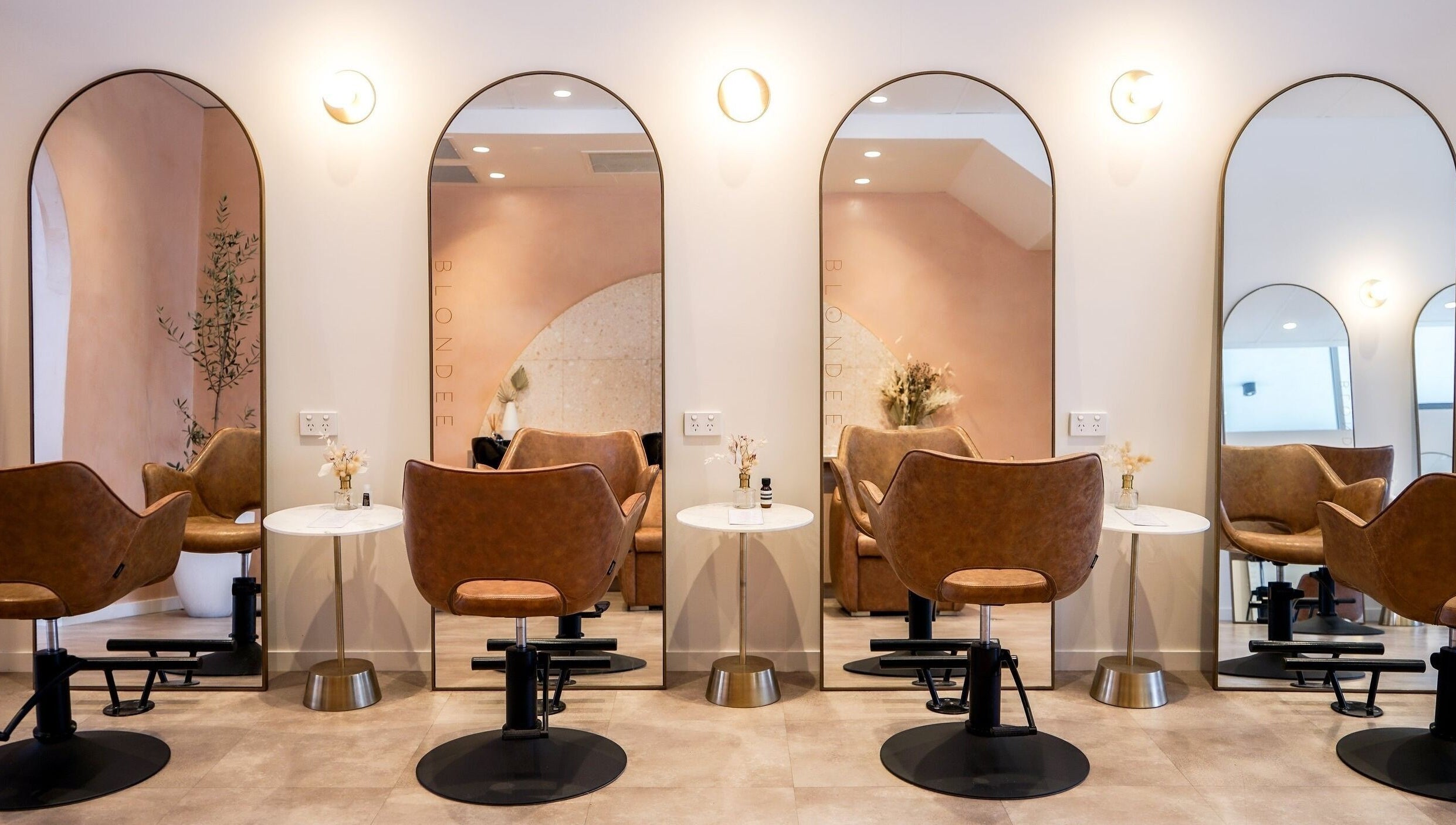 Chic salon interior at Blondee | Newstead with mirrors and stylish chairs, located in Newstead, Queensland, AU.