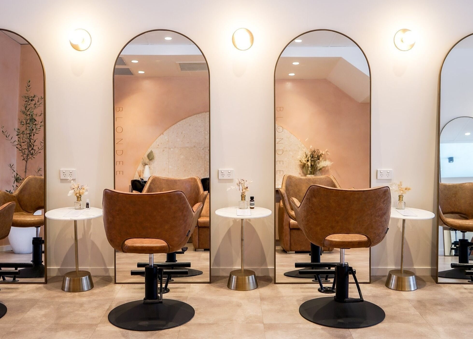 Chic salon interior at Blondee | Newstead with mirrors and stylish chairs, located in Newstead, Queensland, AU.