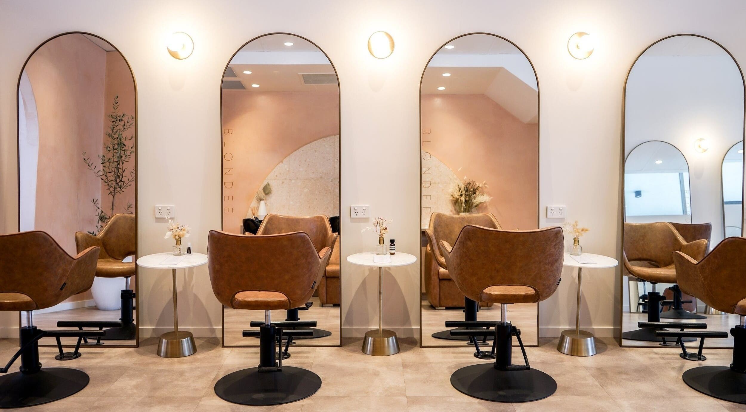 Chic salon interior at Blondee | Newstead with mirrors and stylish chairs, located in Newstead, Queensland, AU.