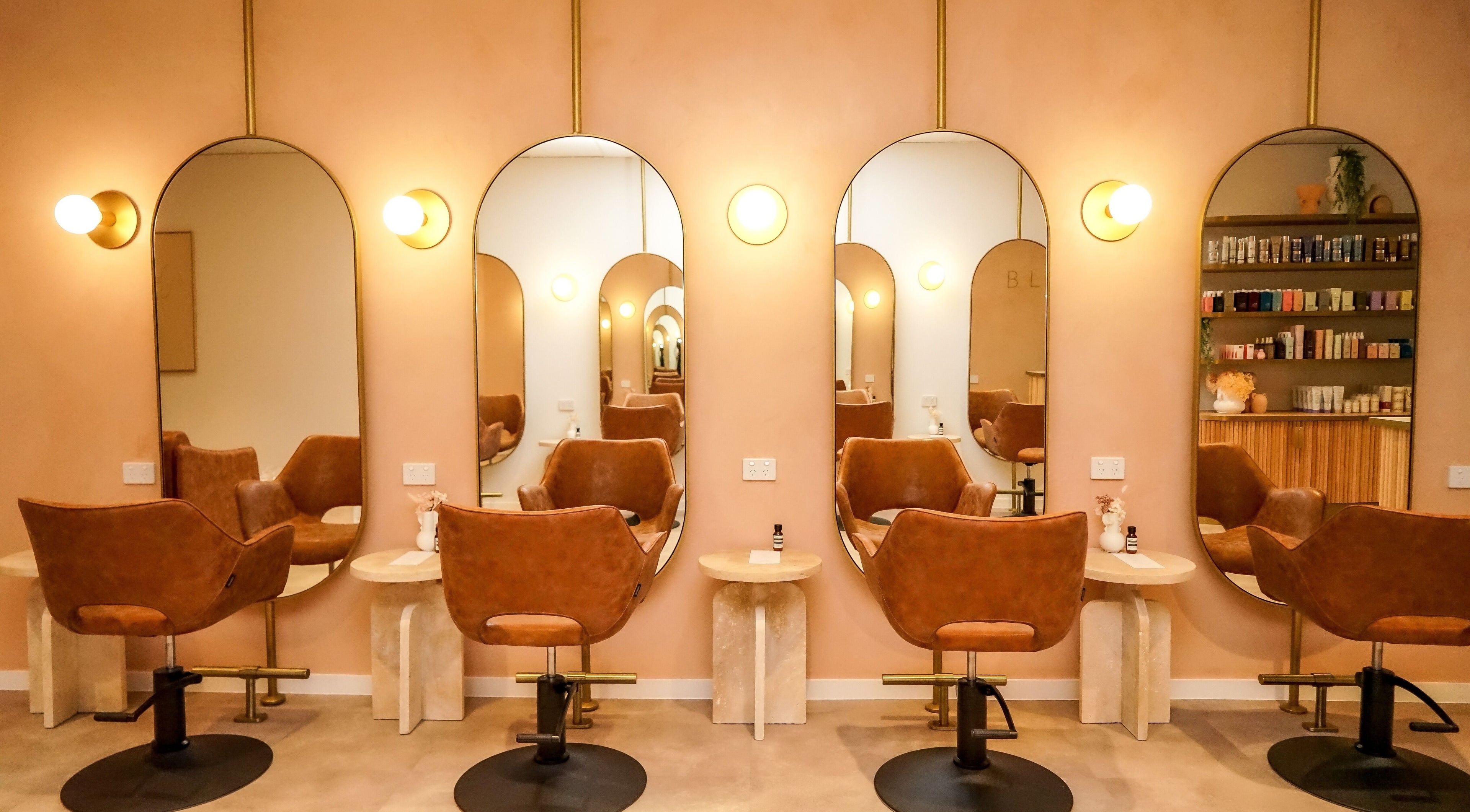 Chic salon interior at Blondee | Morningside, Queensland, AU with stylish chairs and mirrors.