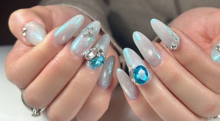Intricate jeweled nail art by Nails By Lexie, Montréal, Québec, CA, featuring blue and silver accents.