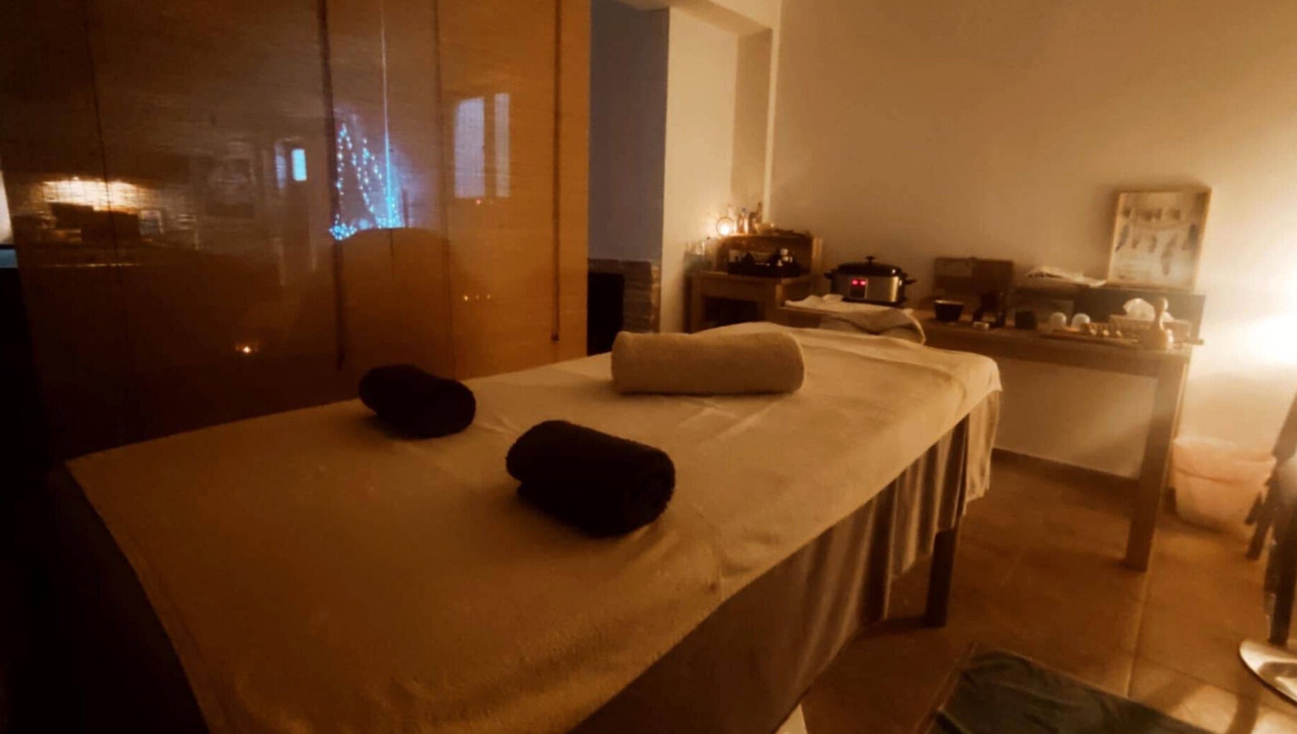 A serene massage room at Spiritual Wellness Retreat in Νέα Μάκρη, Μαραθώνος, GR, with soft lighting.