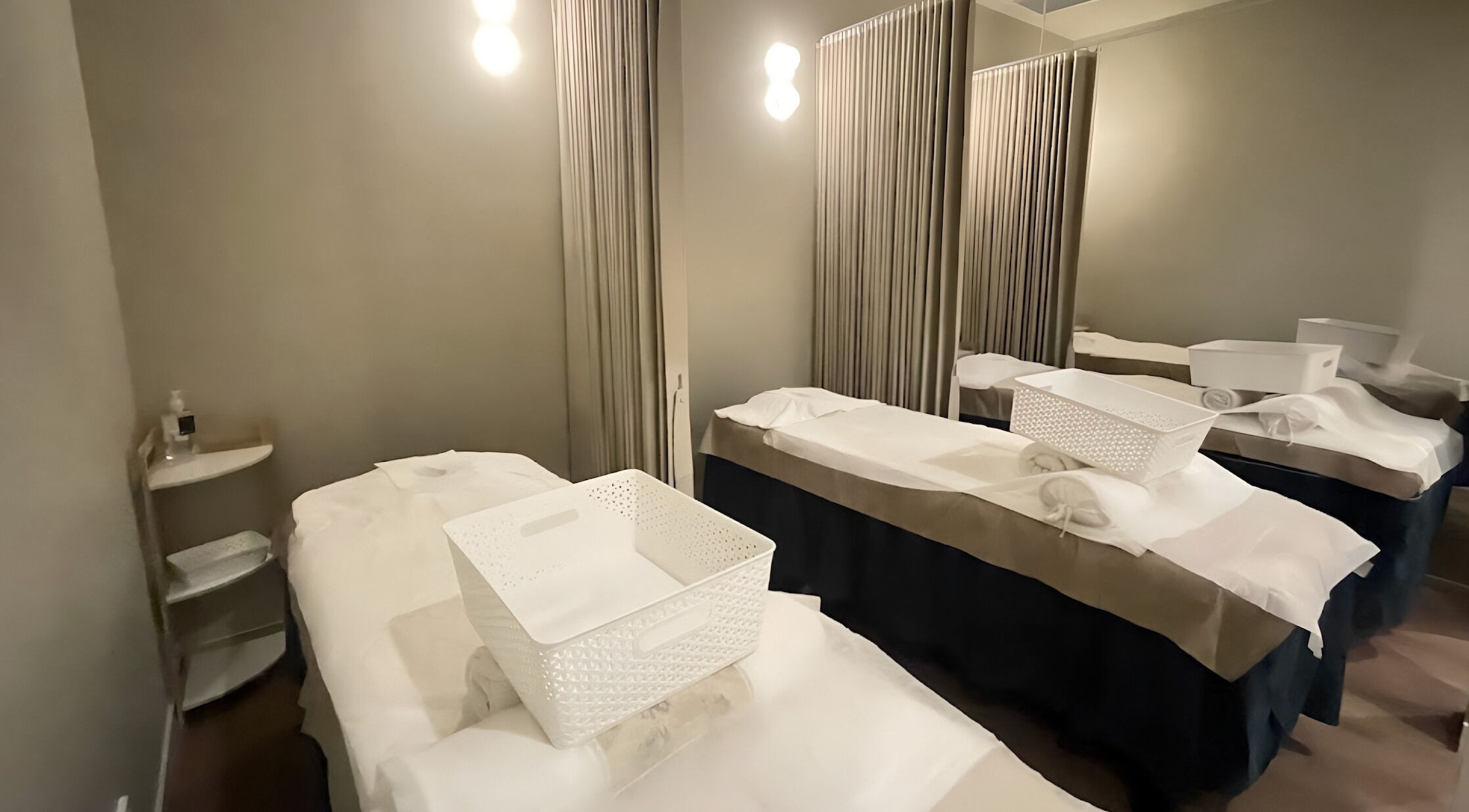 Cozy massage room at Paradise Massage Oasis in Broadbeach, Queensland, AU featuring soft lighting and plush tables.