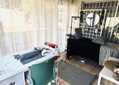 Chic interior of Lenails Beauty Salon in Krugersdorp, Gauteng, ZA featuring manicure station and plush decor.