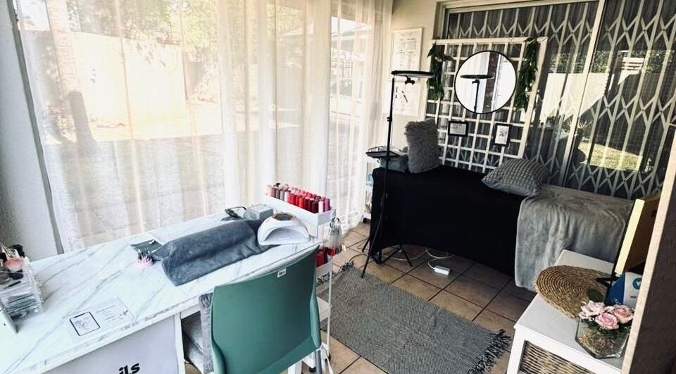 Chic interior of Lenails Beauty Salon in Krugersdorp, Gauteng, ZA featuring manicure station and plush decor.