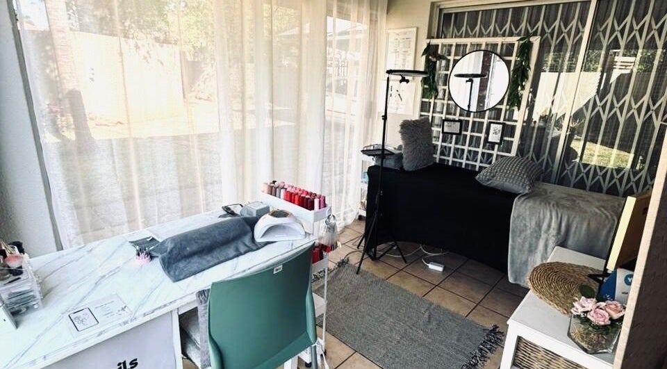 Chic interior of Lenails Beauty Salon in Krugersdorp, Gauteng, ZA featuring manicure station and plush decor.