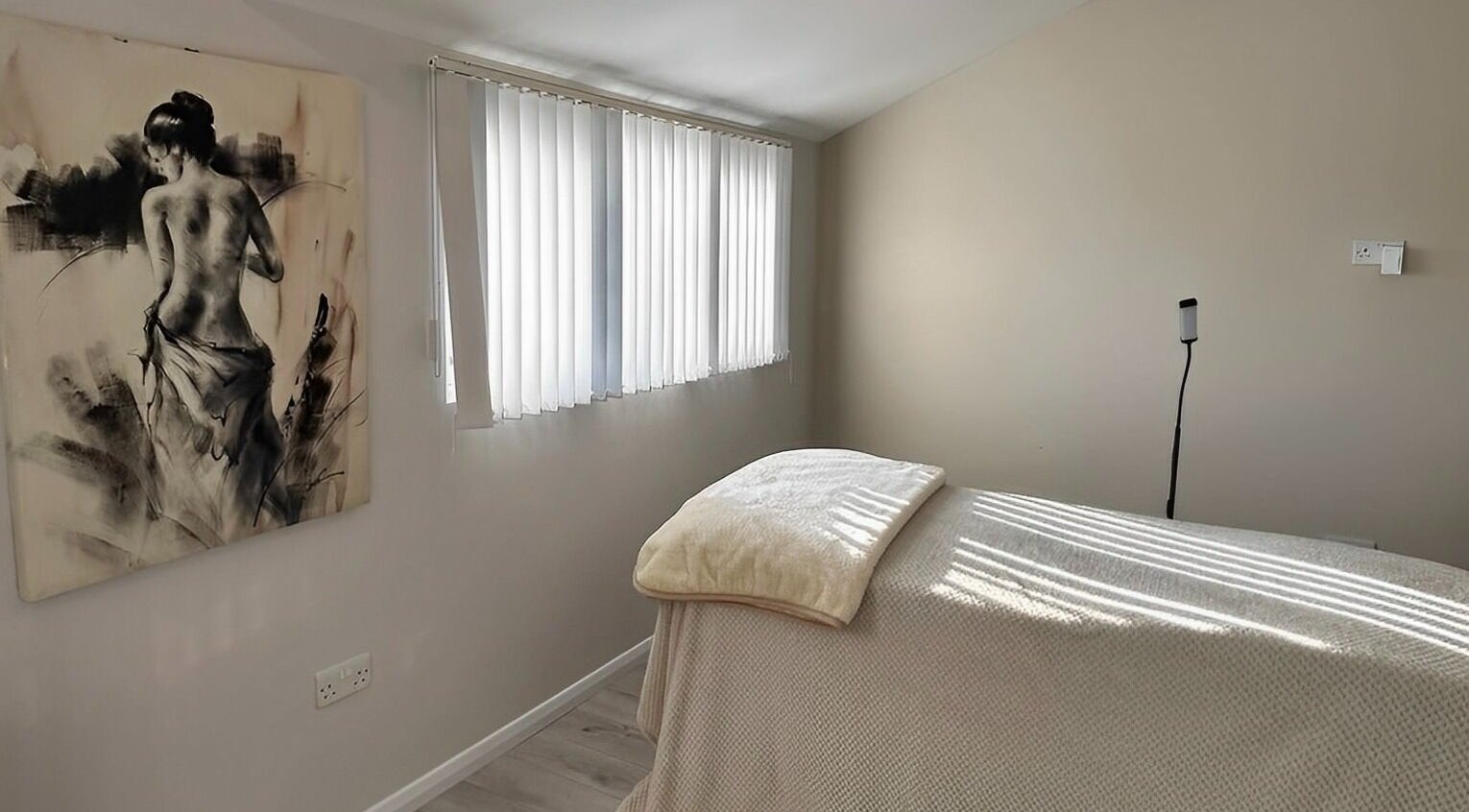 Serene massage room at Beauty by Nicole, Milton Keynes, GB, with soothing decor and natural light.