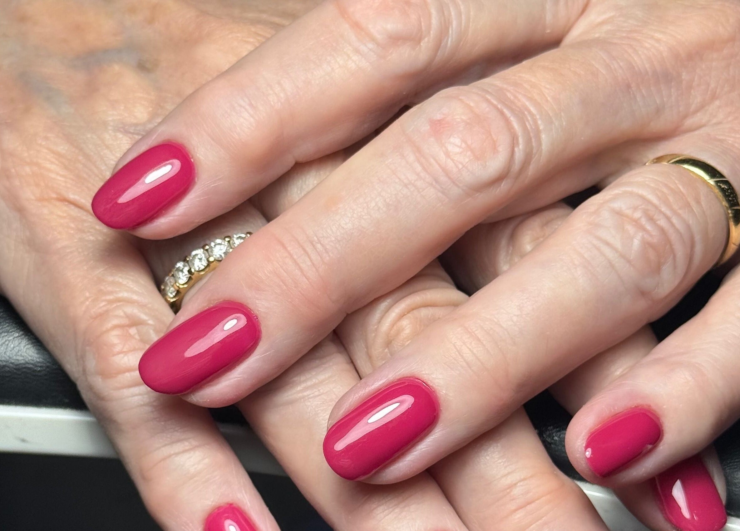 Elegant crimson manicure at The Flying Nail Tech, Middlewich, England, GB. Perfectly polished nails showcase sophistication.