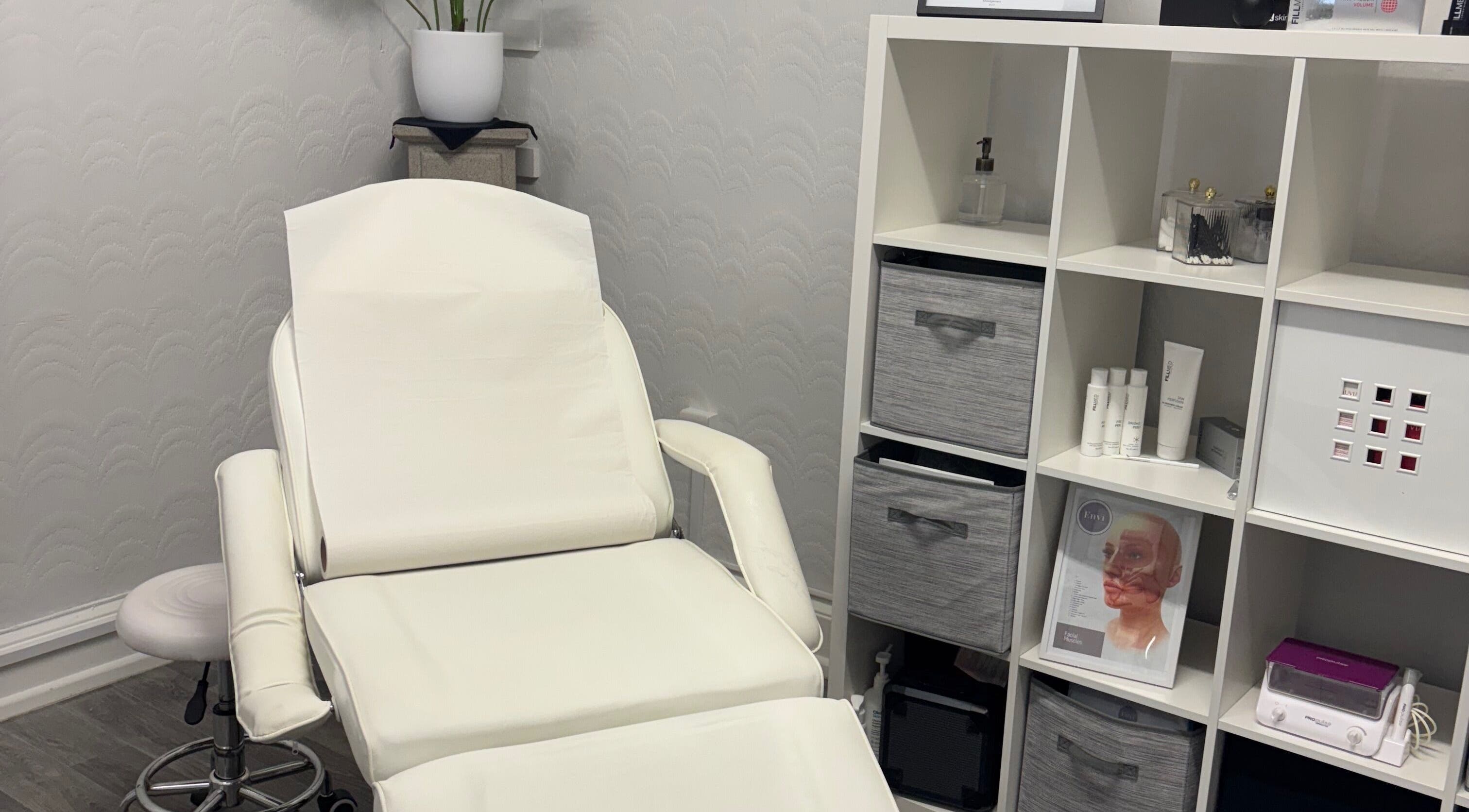 Cozy treatment room at Sugar Studio in Envi Clinic, Ballyclare, Northern Ireland, GB with a stylish white chair.