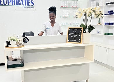 Reception desk at Euphrates Wellness Clinic - Monument Park, Centurion, Gauteng, ZA with staff and floral display.