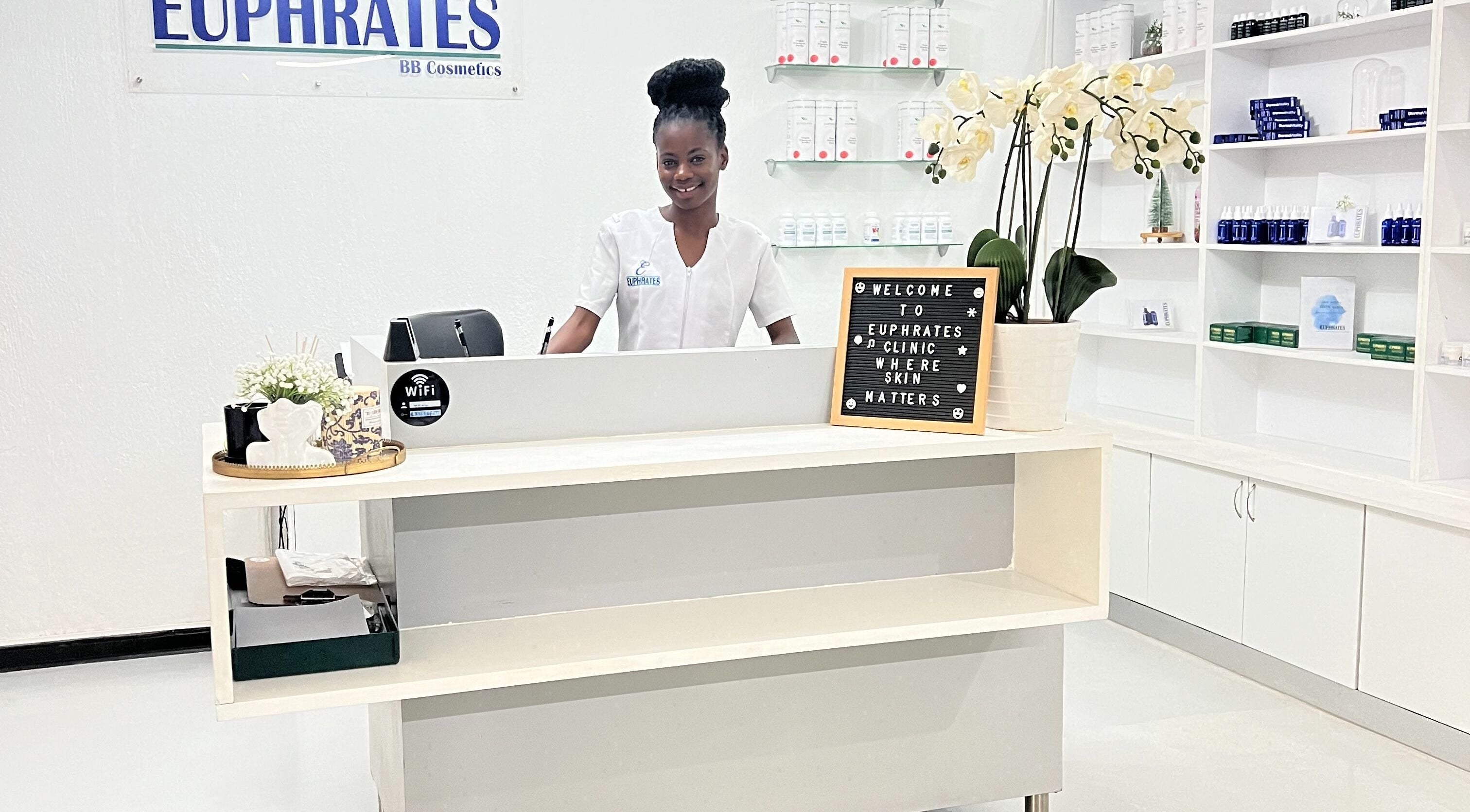 Reception desk at Euphrates Wellness Clinic - Monument Park, Centurion, Gauteng, ZA with staff and floral display.