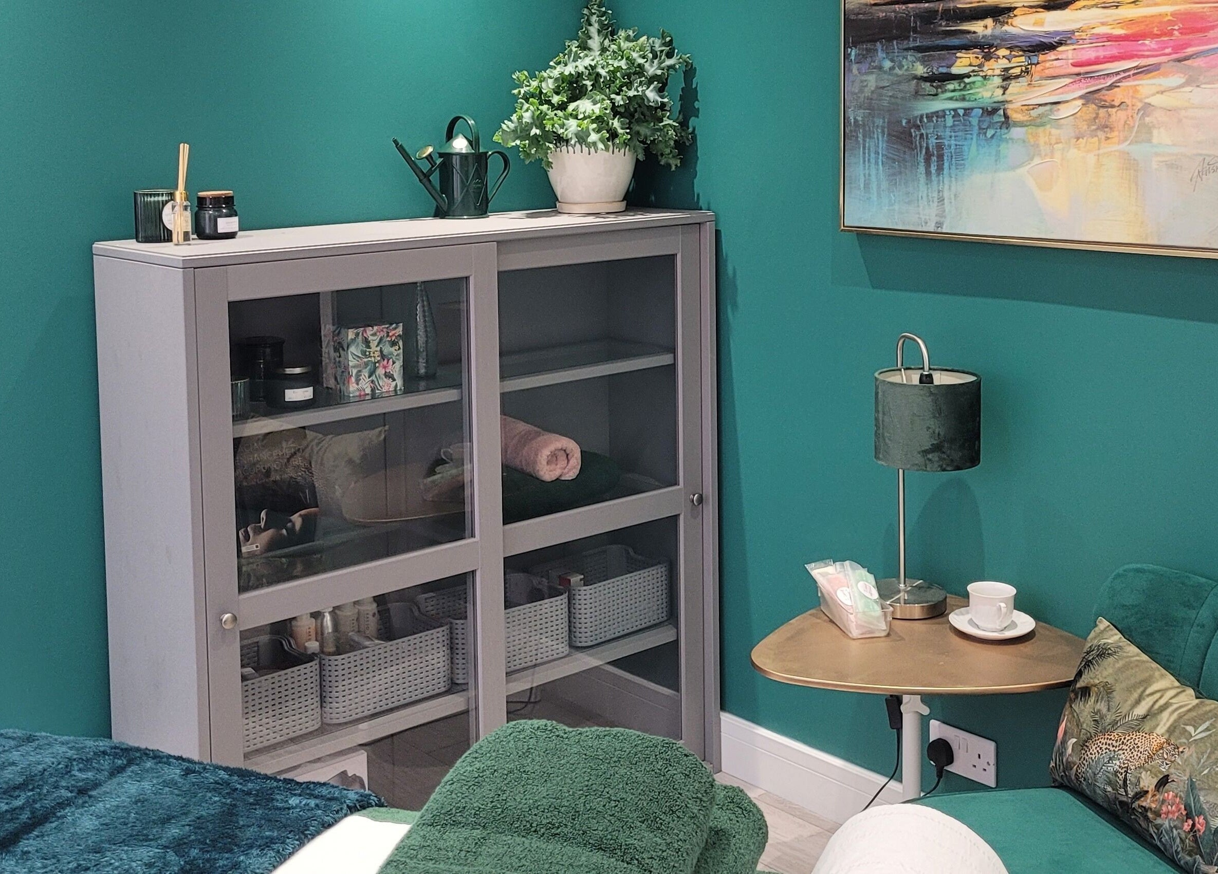 Serene treatment room at Thrive Wellness Centre in Southampton, England, GB with elegant furnishings and vibrant art.