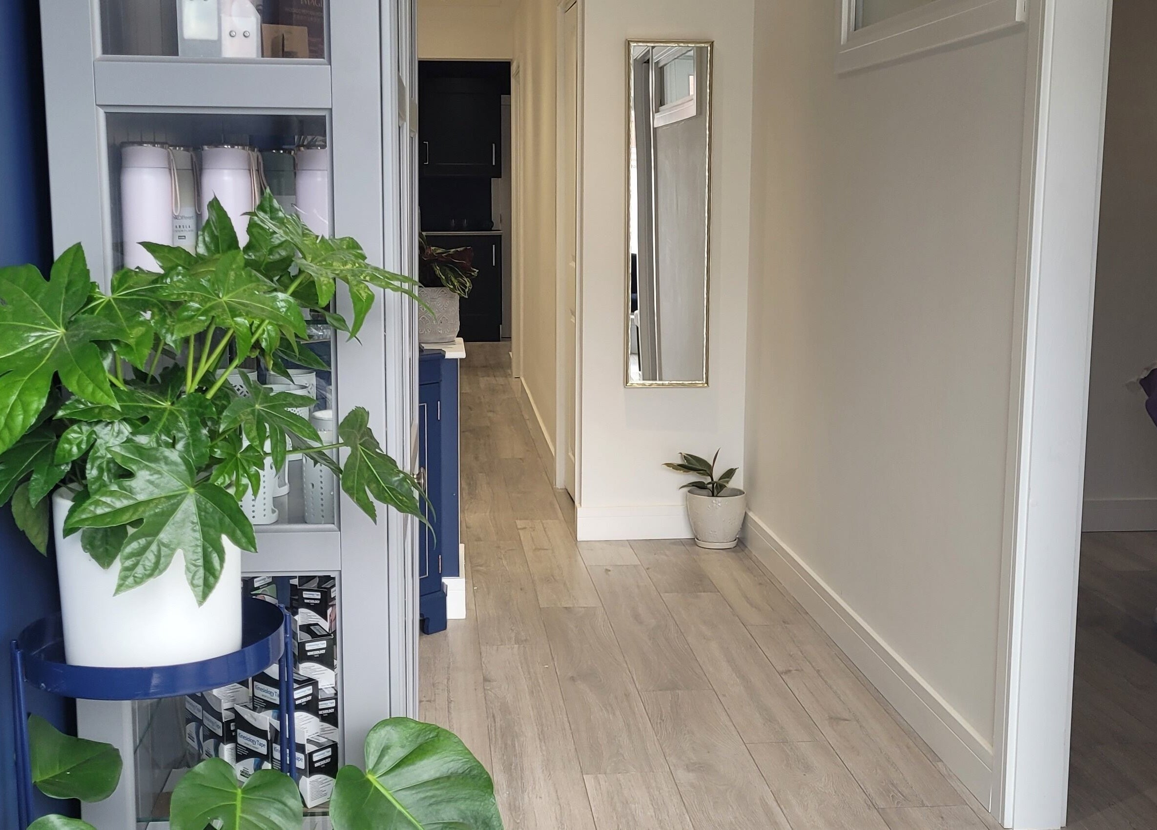 Tranquil corridor at Thrive Wellness Centre, Southampton, England, GB with lush plants and modern decor.
