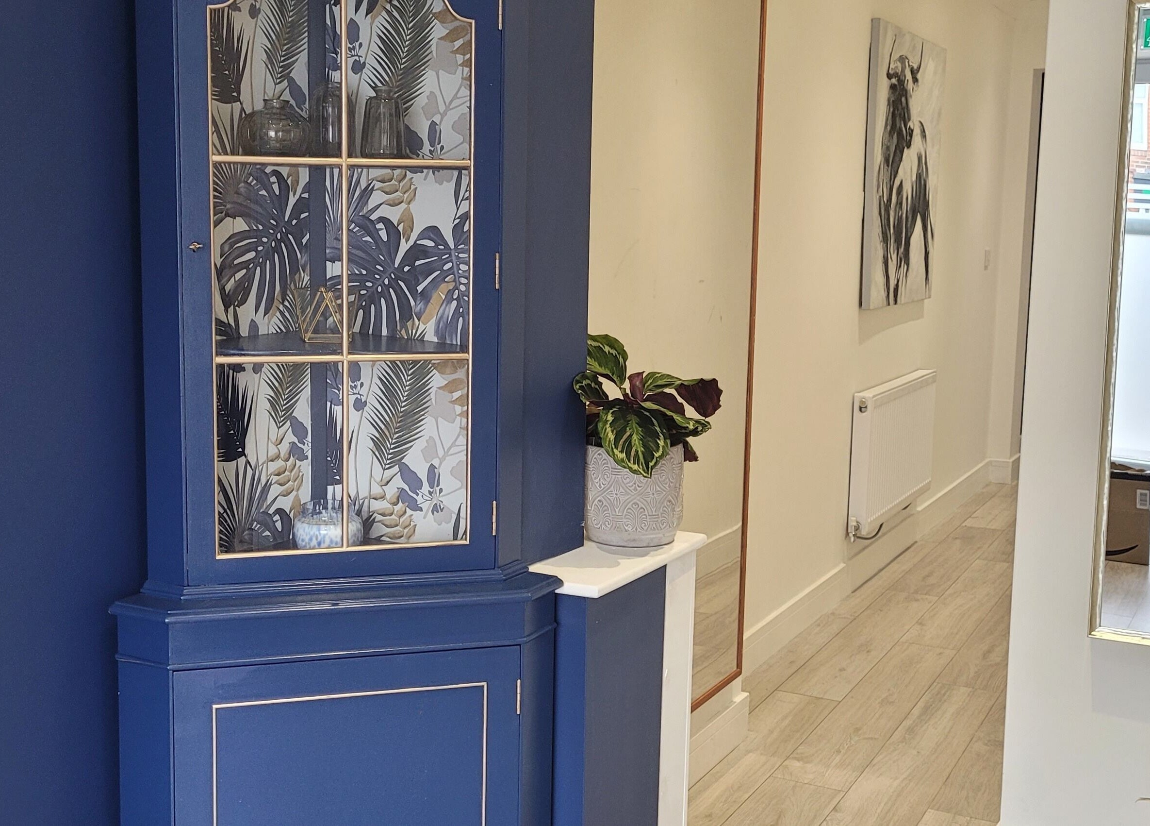 Stylish blue cabinet and decor at Thrive Wellness Centre, Southampton, England, GB. Inviting and serene atmosphere.