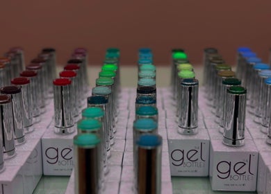 Colorful gel nail polish bottles lined up at South Nail & Beauty Studio, Glasgow, Scotland, GB.