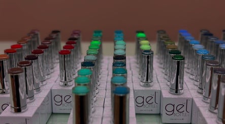 Colorful gel nail polish bottles lined up at South Nail & Beauty Studio, Glasgow, Scotland, GB.