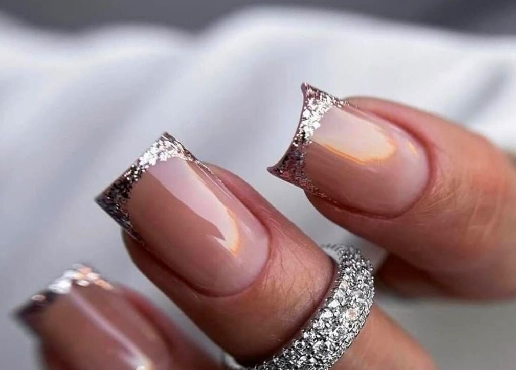 Elegant glitter French nails at NAVY NAIL HAIR BEAUTY STUDIO, Glasgow, Scotland, GB. Perfect for special occasions.