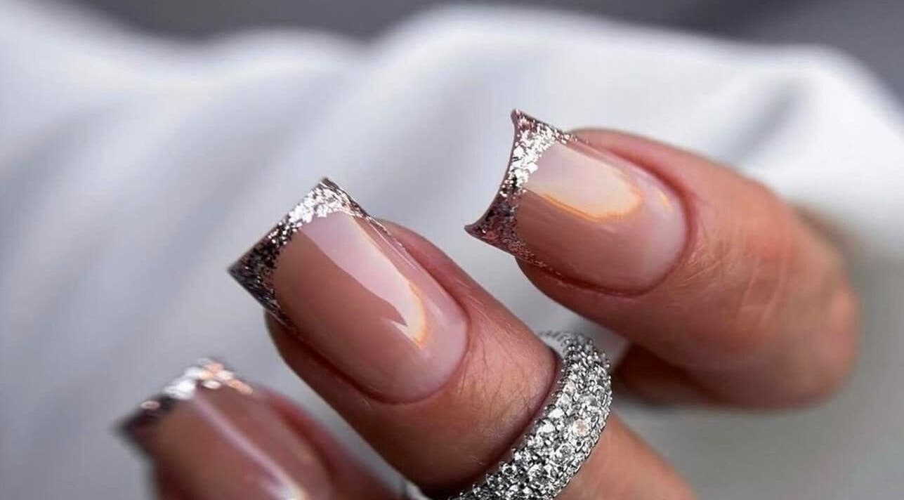 Elegant glitter French nails at NAVY NAIL HAIR BEAUTY STUDIO, Glasgow, Scotland, GB. Perfect for special occasions.