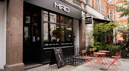 MAD venue entrance with outdoor seating in London, England, GB, showcasing urban elegance.