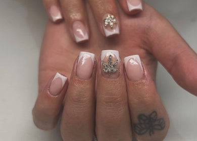Elegant nail art design at Flo's Beauty, Thurmaston, England, GB showcasing sophisticated embellishments.