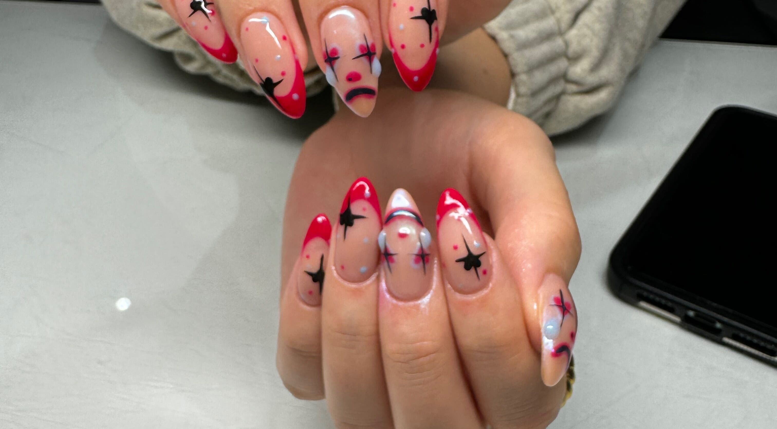 Artistic nail design at Flo’s Beauty in Thurmaston, England, GB. Vibrant colors and unique patterns showcase style.