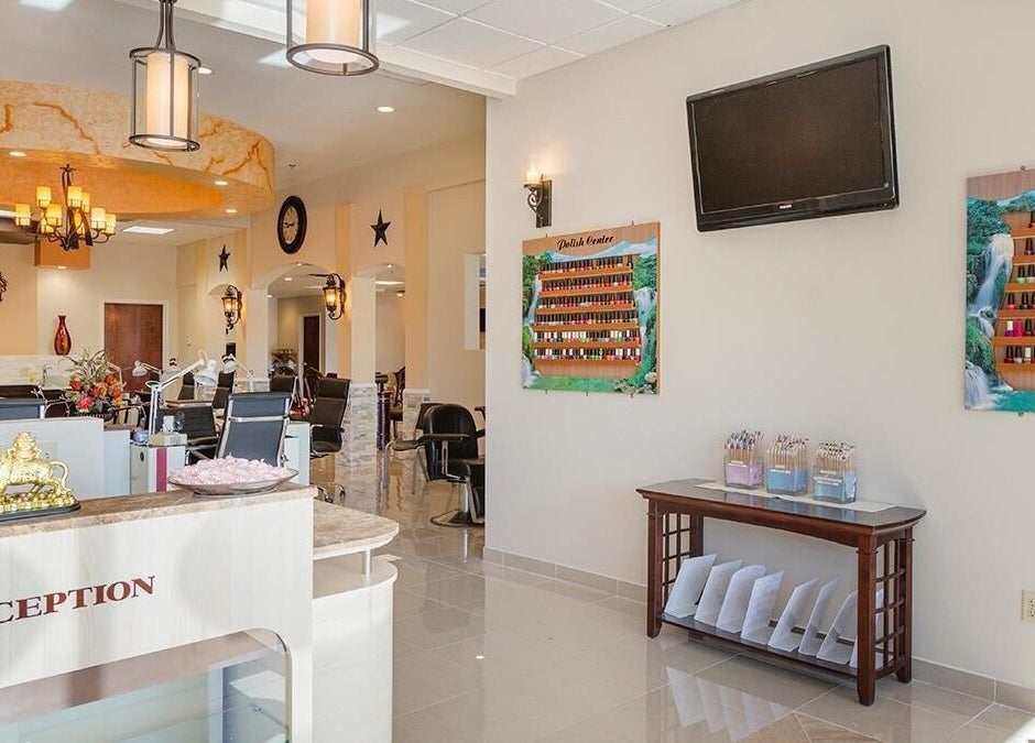 Interior of TT Nail Lounge in Colorado Springs, Colorado, US showcasing elegant reception and nail polish display.