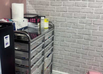 Modern storage with beauty essentials at Unique Aesthetics, Ironville, England, GB. Sleek design and functionality.