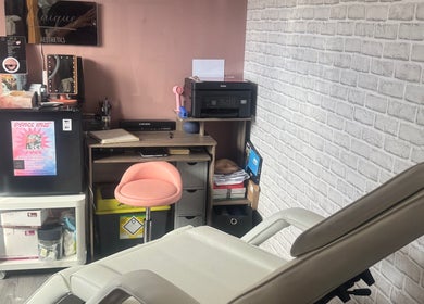Unique Aesthetics cozy treatment room in Ironville, England with reclining chair and modern decor.