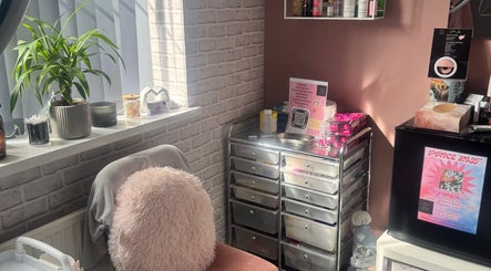 Cozy beauty corner at Unique Aesthetics, Ironville, England, GB showcasing skincare products and soothing decor.