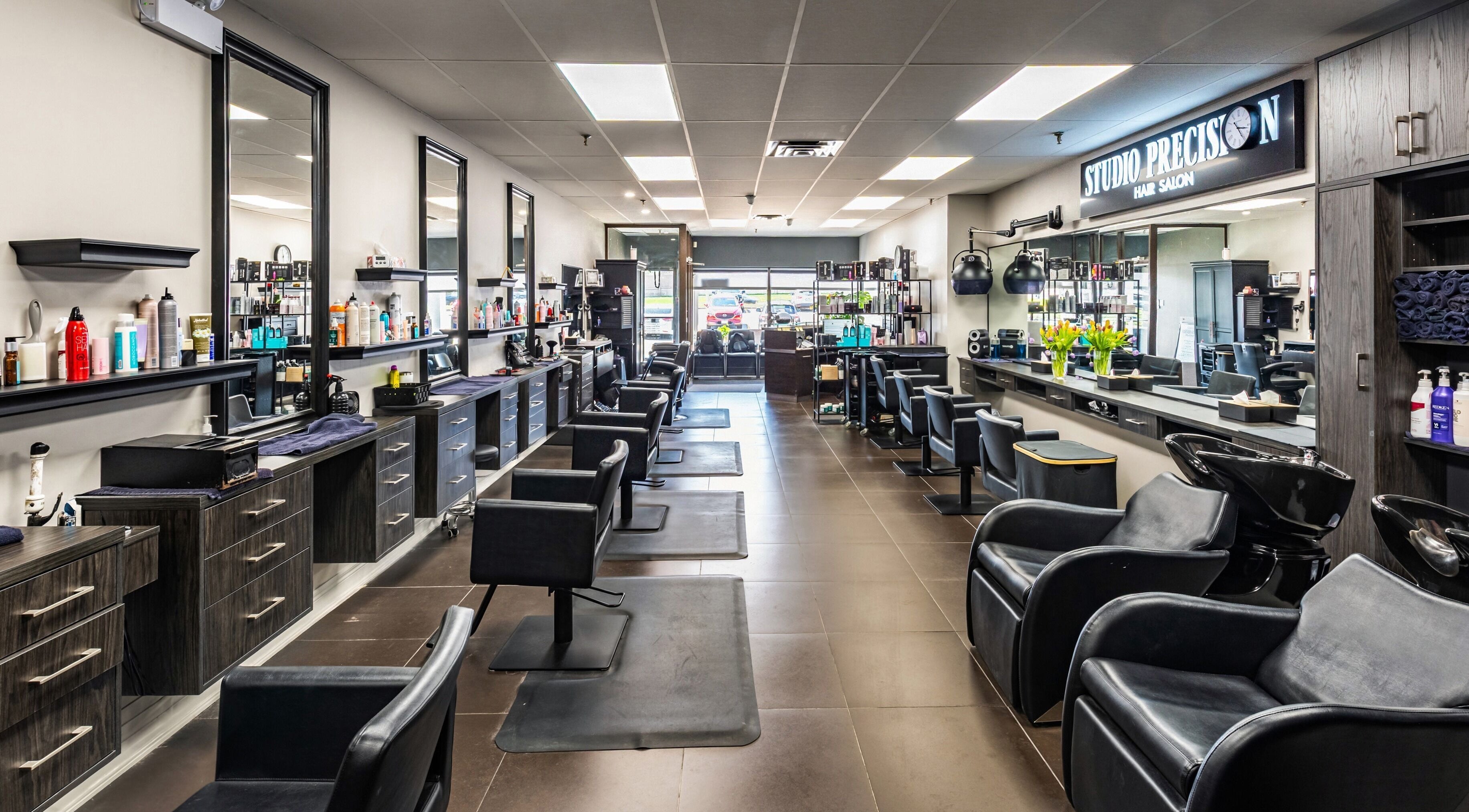 Modern interior of Studio Precision Hair Salon in Burlington, Ontario, CA showcasing sleek hair styling stations.