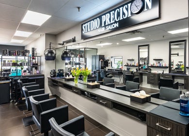 Modern setup at Studio Precision Hair Salon in Burlington, Ontario, CA showcasing stylish chairs and decor.