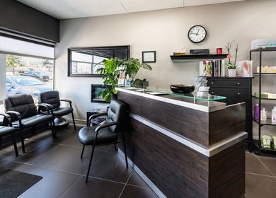 Welcoming reception at Studio Precision Hair Salon, Burlington, Ontario, CA, with seating and product displays.