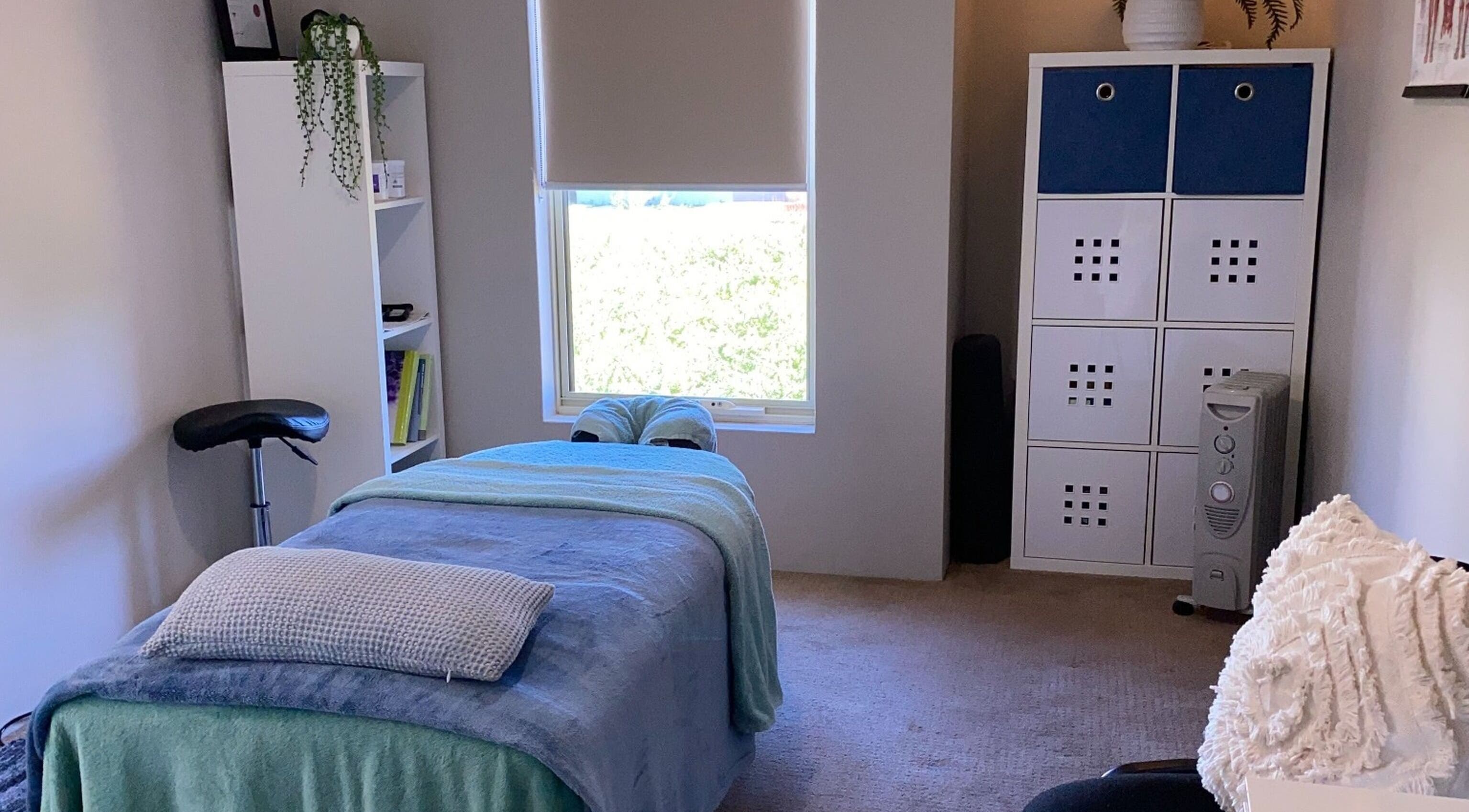 A serene massage room at CQ Massage Therapy, City Of Wanneroo, Western Australia, AU, featuring a cozy treatment bed.