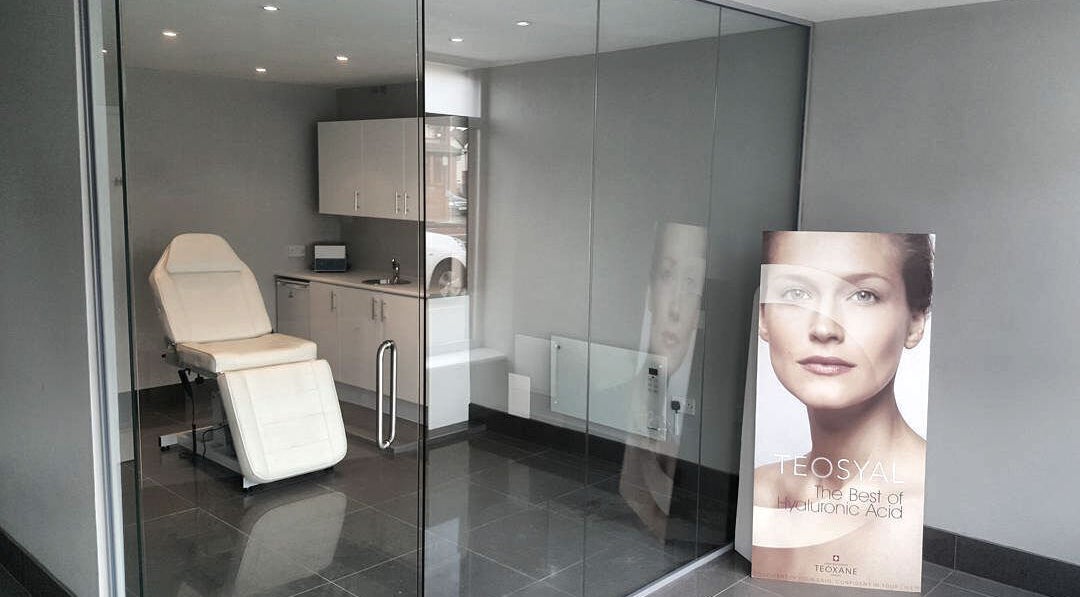 Modern treatment room at Kerrie Lynch Aesthetics, Manchester, England, GB, featuring a sleek chair and calming decor.