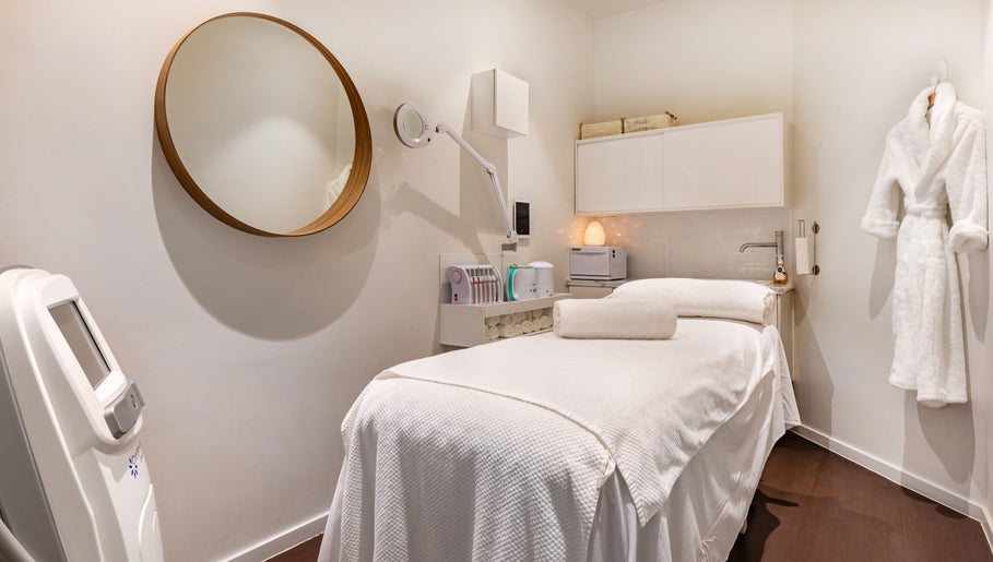 Luxurious spa treatment room at Doncaster East, Victoria, AU featuring a treatment bed and elegant decor.